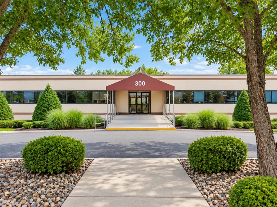 Entrance to 300 North Middletown Road under a burgundy awning